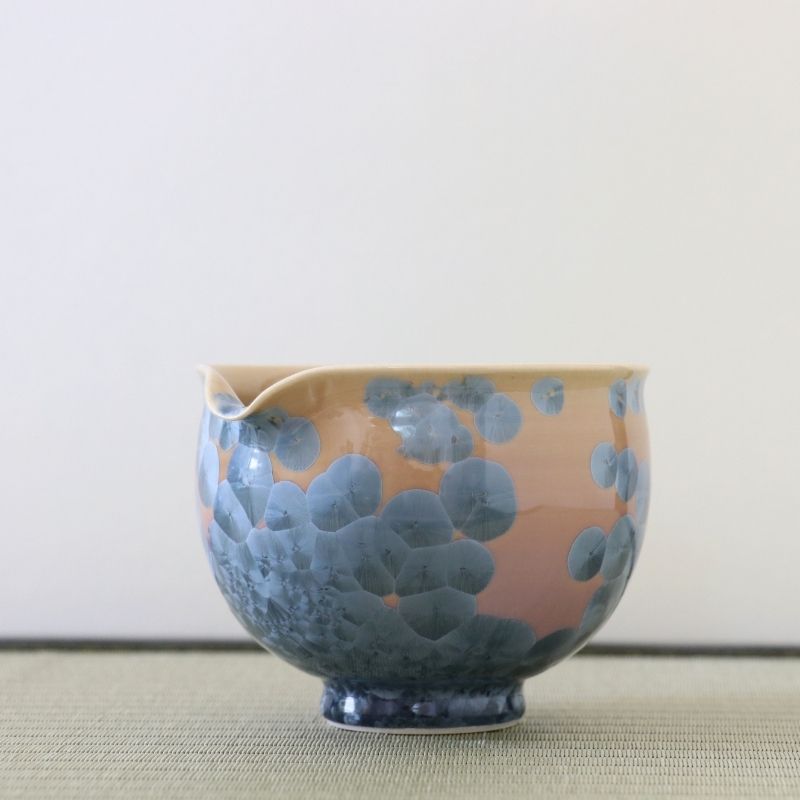 Side view of the Tōan Hana-Kesshō Ash Blue katakuchi bowl showing its rounded form, pouring spout, and layered blue-gray flower crystal glaze