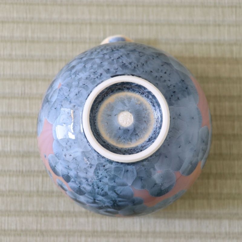 Underside view of the Tōan Hana-Kesshō Ash Blue katakuchi bowl showing its circular ceramic foot and flower crystal glaze across the base