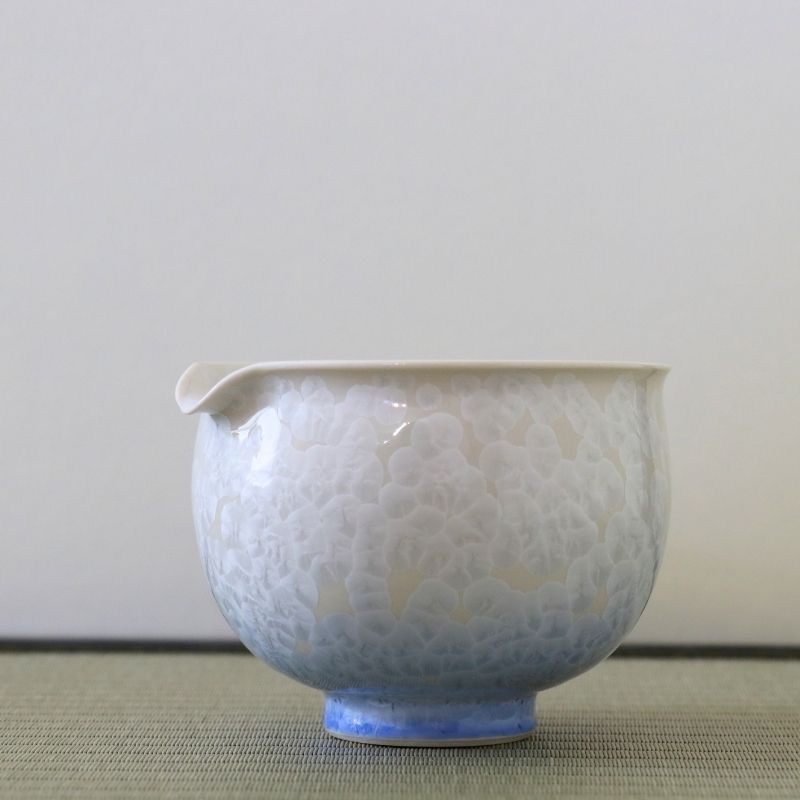 Side view of the Tōan Hana-Kesshō blue and white gradation katakuchi bowl showing its rounded form, pouring spout, and soft crystalline glaze transition