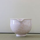 Spout view of the Tōan cherry blossom pink katakuchi matcha latte bowl highlighting the pouring lip and delicate Hana-Kesshō crystalline glaze
