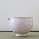 Tōan katakuchi matcha latte pouring bowl featuring a soft cherry blossom pink Hana-Kesshō flower crystal glaze with delicate pale crystalline patterns