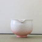 Spout view of the Tōan katakuchi matcha latte bowl highlighting the small pouring lip and pink and white flower crystal glaze