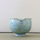 Spout view of the Tōan green katakuchi matcha latte bowl highlighting the pouring lip and pale blue-green crystalline glaze patterns