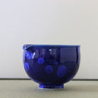 Side view of the Tōan Hana-Kesshō katakuchi bowl showing its rounded form, pouring spout, and deep lapis blue crystalline glaze