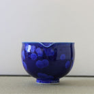 Spout view of the Tōan lapis blue katakuchi matcha latte bowl highlighting the pouring lip and lighter blue flower crystal glaze patterns