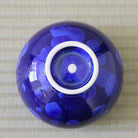 Underside view of the Tōan Hana-Kesshō lapis blue katakuchi bowl showing its circular ceramic foot and crystalline glaze across the base