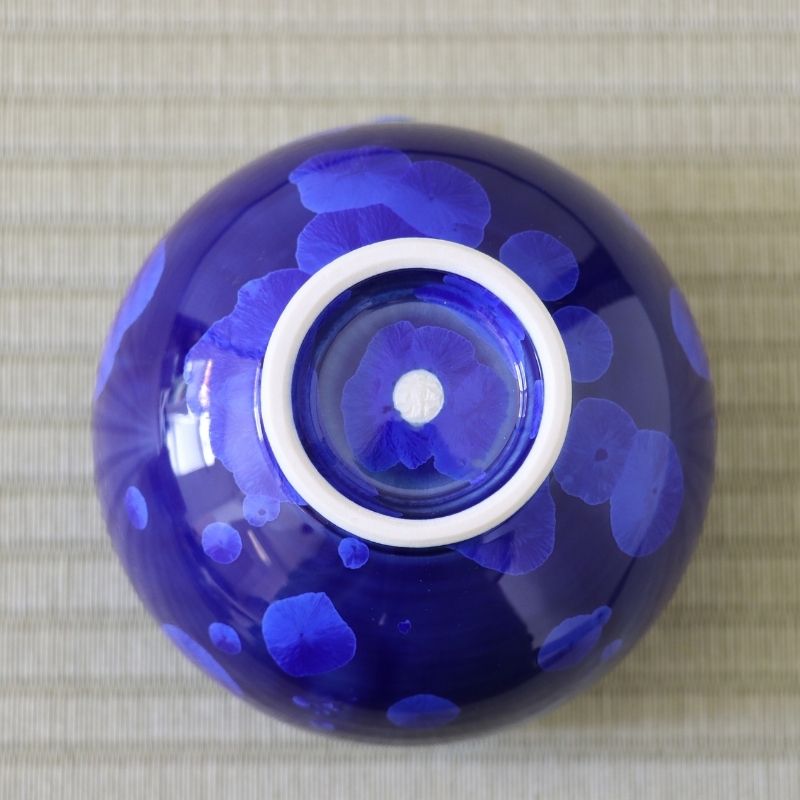 Underside view of the Tōan Hana-Kesshō lapis blue katakuchi bowl showing its circular ceramic foot and crystalline glaze across the base