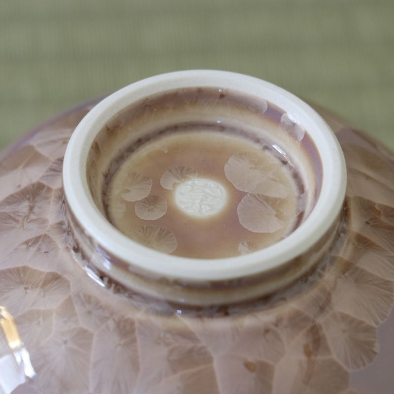 Close-up of the ceramic foot on the Tōan mocha katakuchi bowl showing the unglazed foot ring and surrounding Hana-Kesshō crystalline glaze