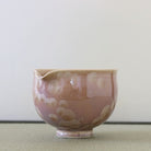 Side view of the Tōan Hana-Kesshō mocha katakuchi bowl showing its rounded form, pouring spout, and cream flower crystal glaze patterns
