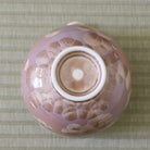 Underside view of the Tōan Hana-Kesshō mocha katakuchi bowl showing its circular ceramic foot and flower crystal glaze across the base