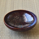 Top interior view of the Touan Hoshi-Kessho wine red matcha bowl showing radiant star-like crystal patterns across the glossy interior glaze