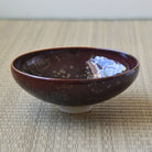 Touan flat matcha bowl featuring a wine red Hoshi-Kessho Star Crystal glaze with intricate iridescent star-like crystalline patterns