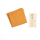 Orange silk fukusa with protective paper sleeve for Japanese Tea Ceremony