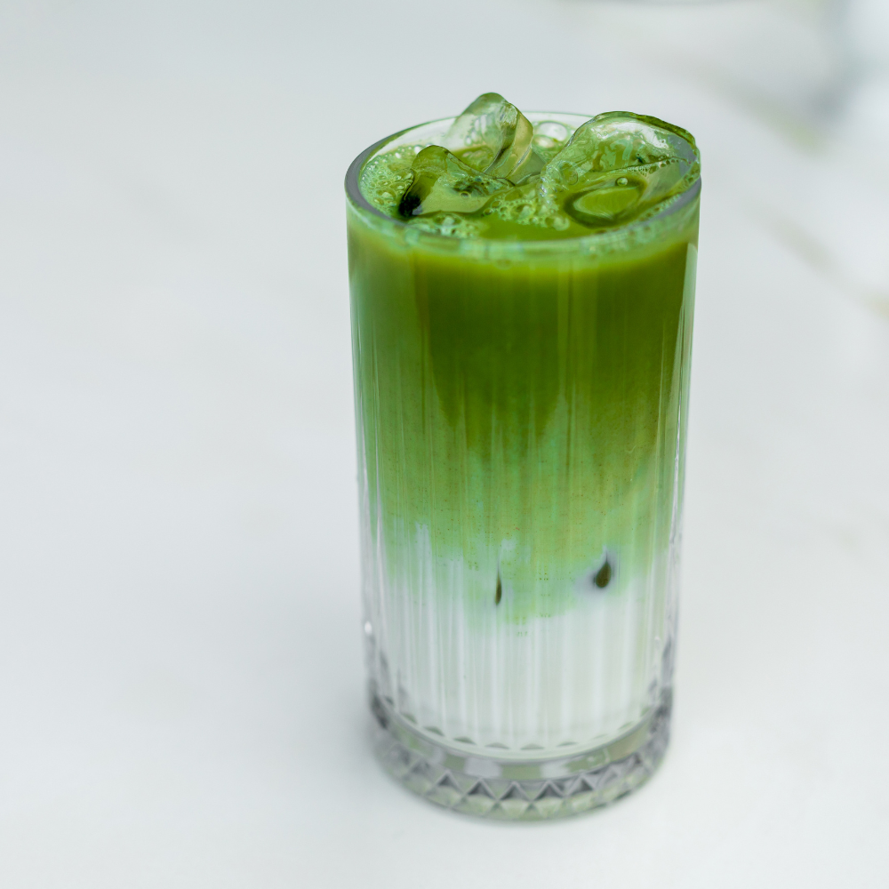Green iced drink in a glass with a white background