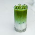 Green iced drink in a glass with a white background