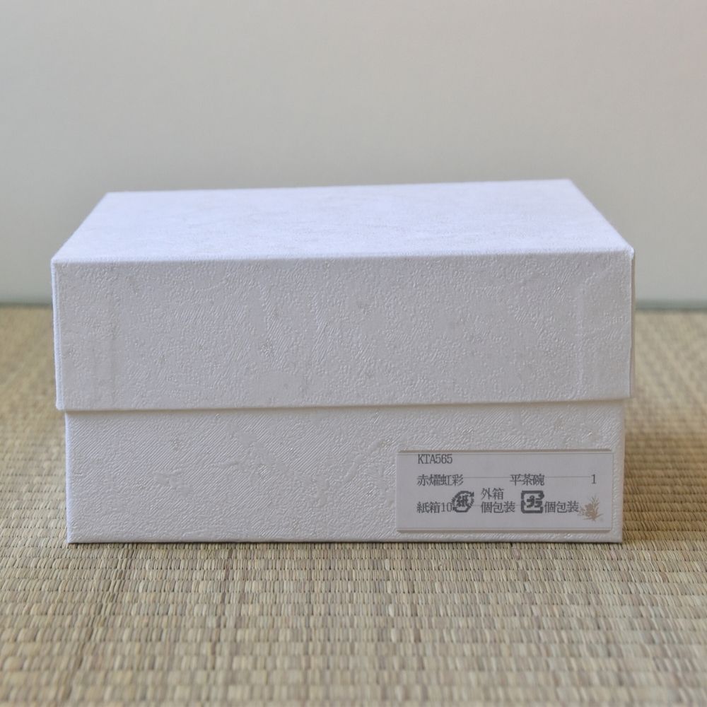 White textured box with a label on a beige surface