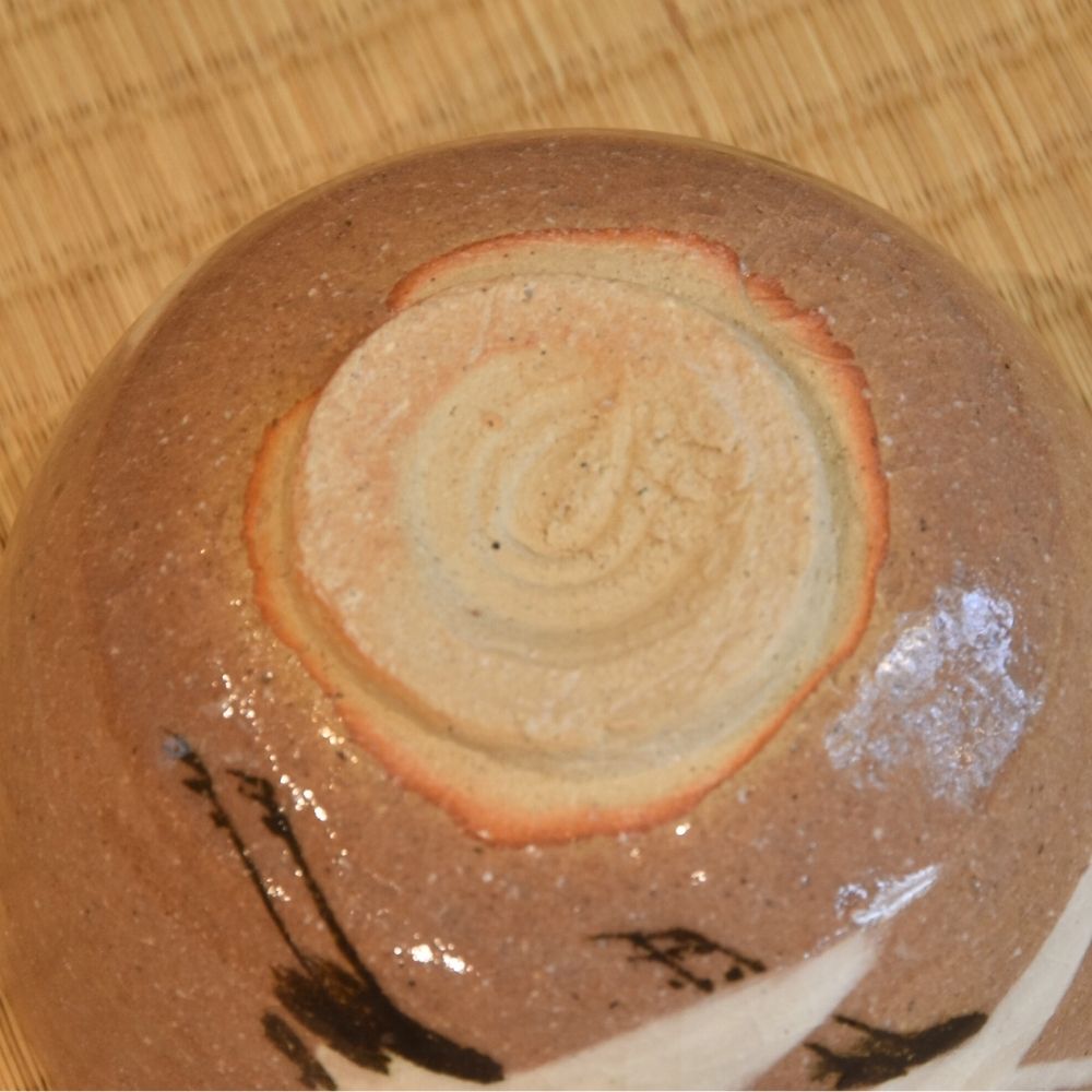 Close-up of the circular foot and textured brown underside of the Zouho Kiln Mino Ware matcha bowl.