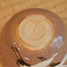 Close-up of the circular foot and textured brown underside of the Zouho Kiln Mino Ware matcha bowl.