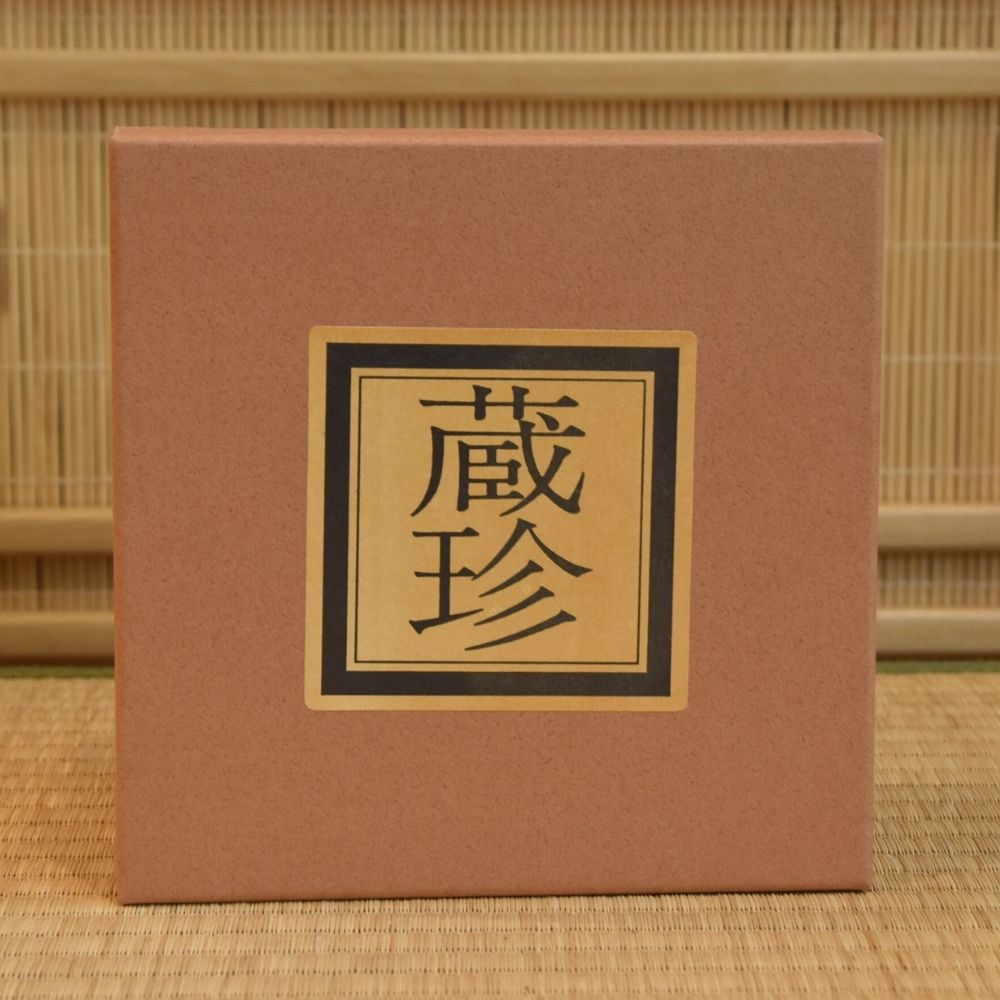 Brown presentation box with a gold and black Japanese label included with the Zouho Kiln Dancing Cranes matcha bowl.