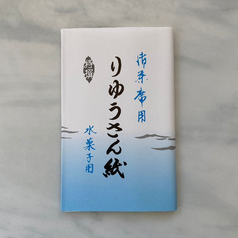 White notebook with blue gradient cover on a marble surface